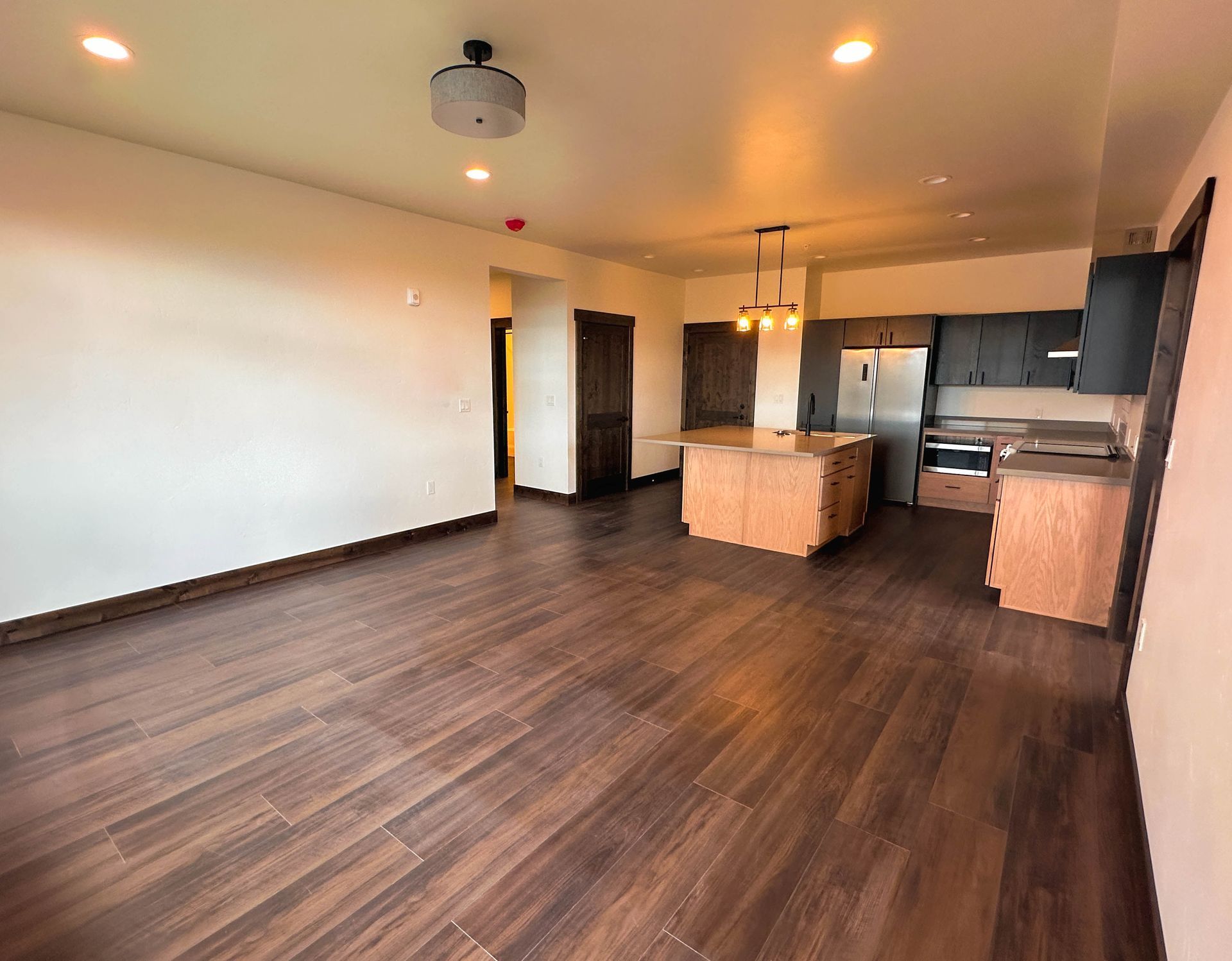 a kitchen with a large island and stainless steel appliances