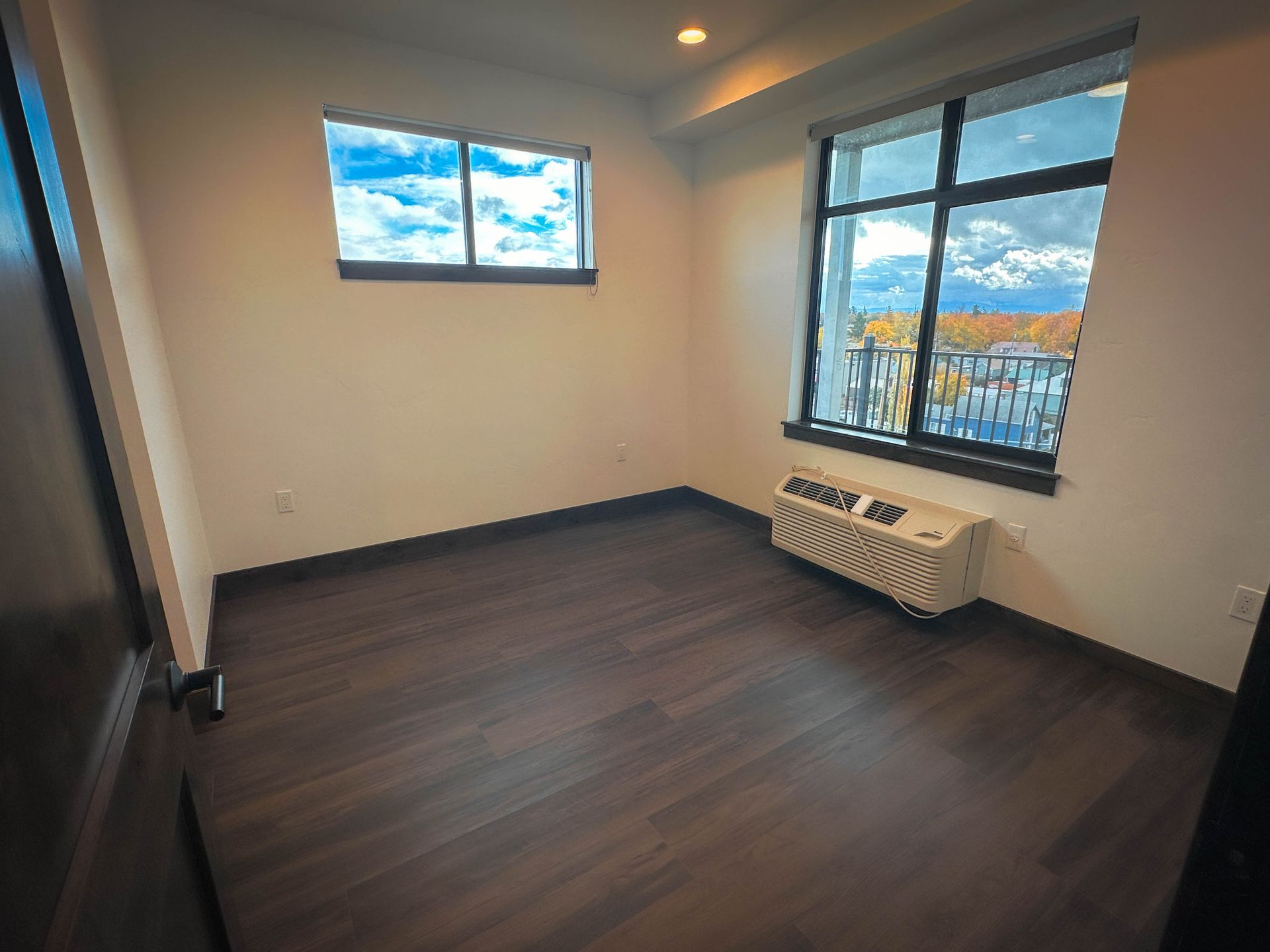 a room with a window and a small air conditioner