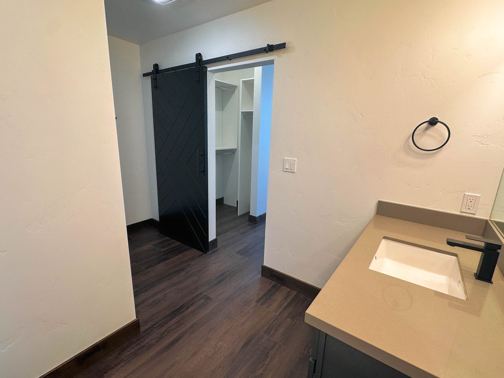 a bathroom with a sliding barn door and a sink