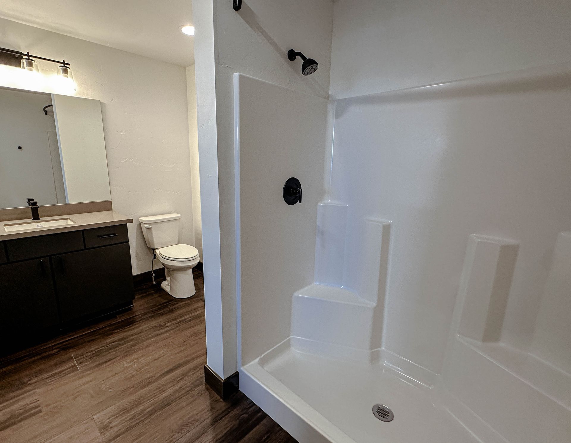 a bathroom with a toilet a sink and a shower