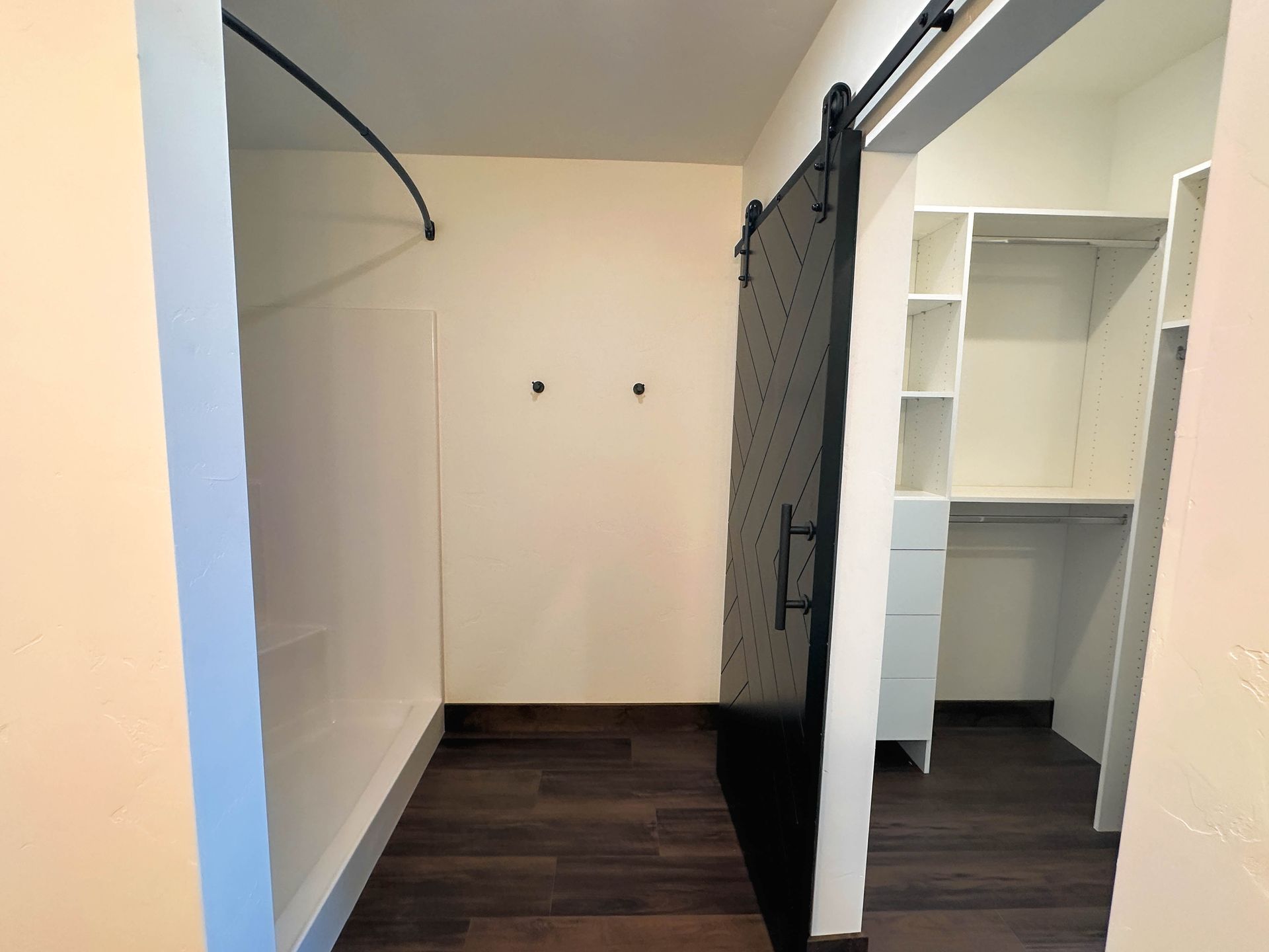a closet with a black sliding barn door