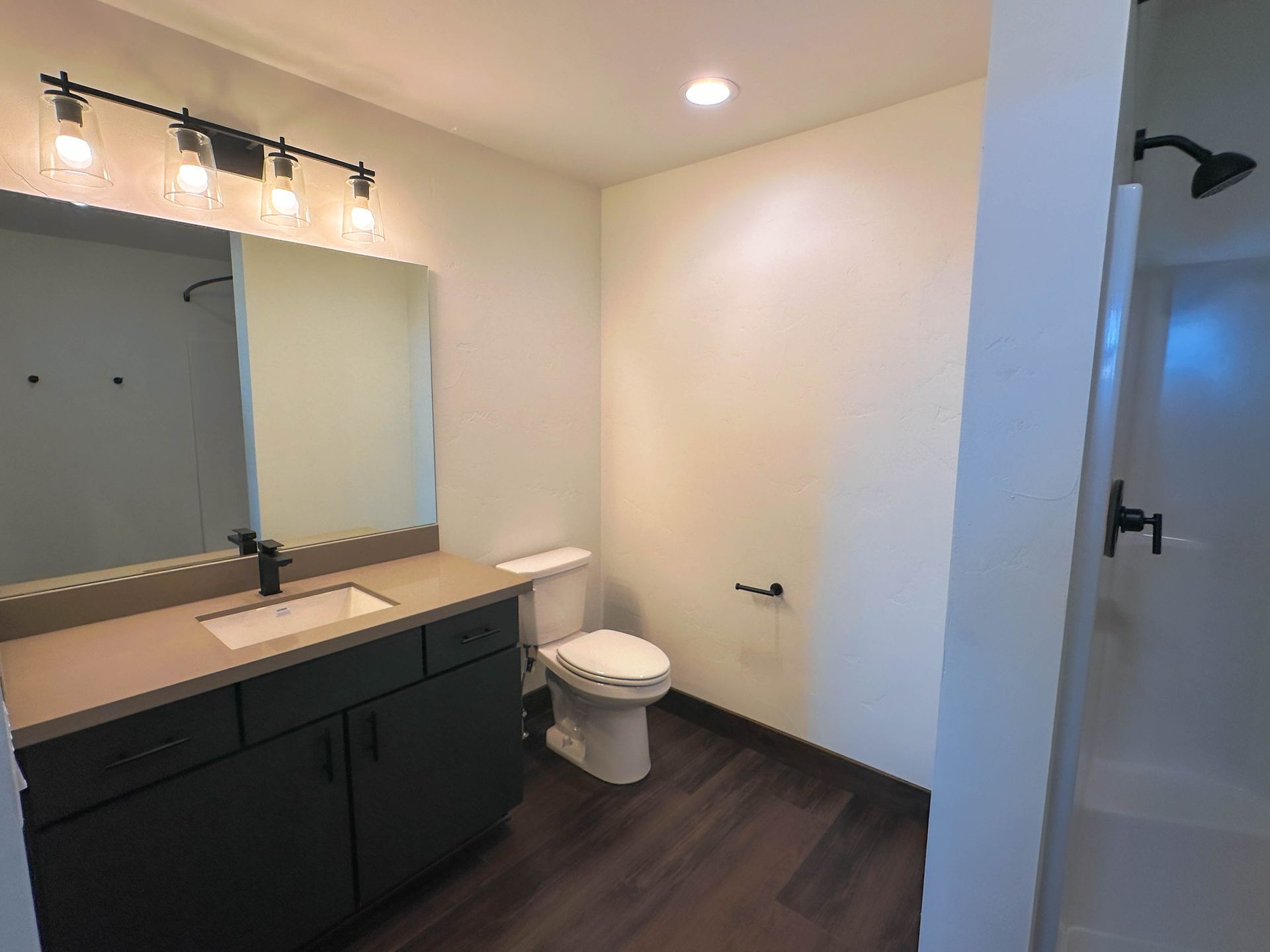 a bathroom with a toilet a sink and a mirror