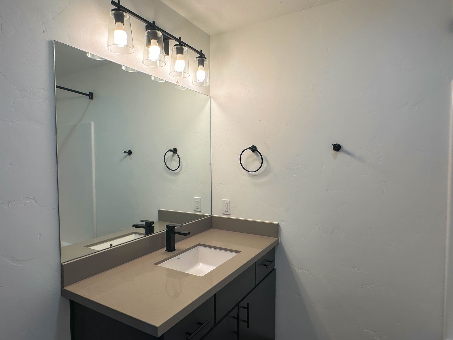 a bathroom with a sink and a large mirror