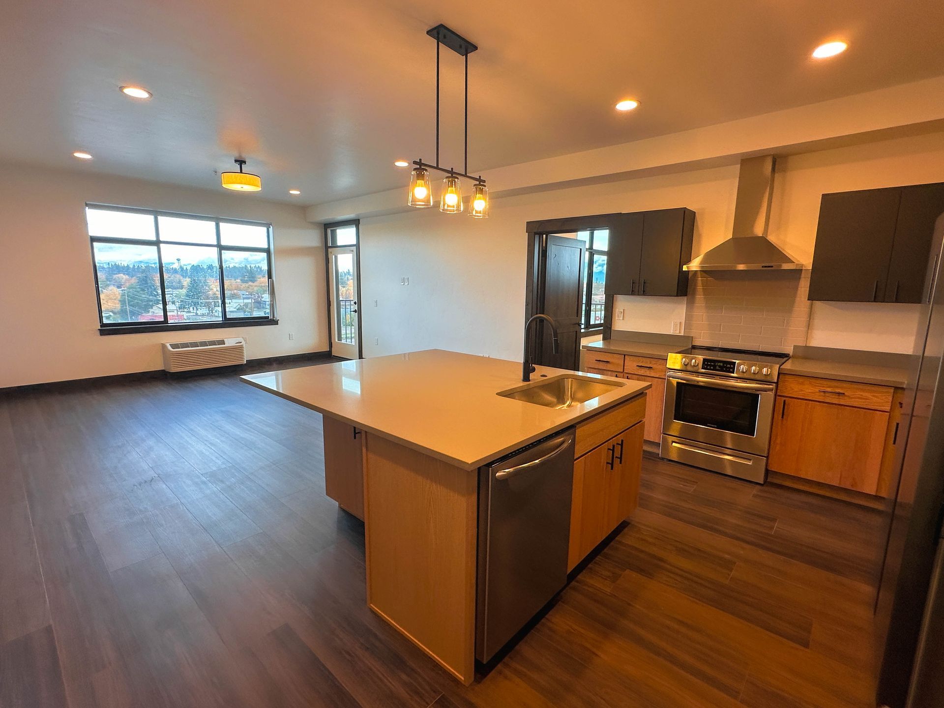 a kitchen with a large island and stainless steel appliances
