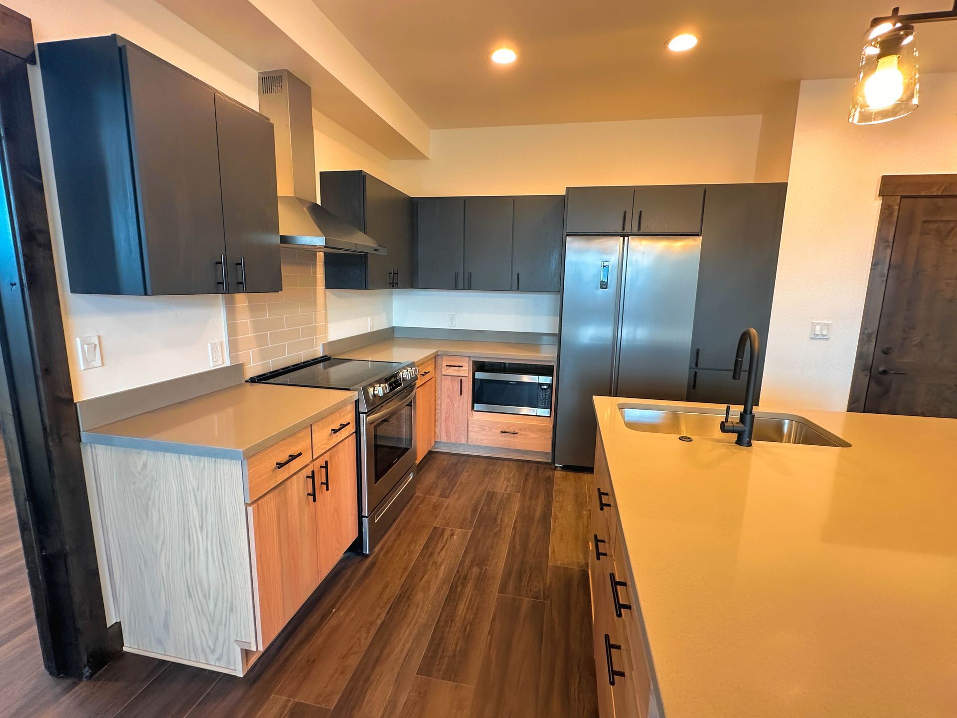 a kitchen with stainless steel appliances and wooden cabinets