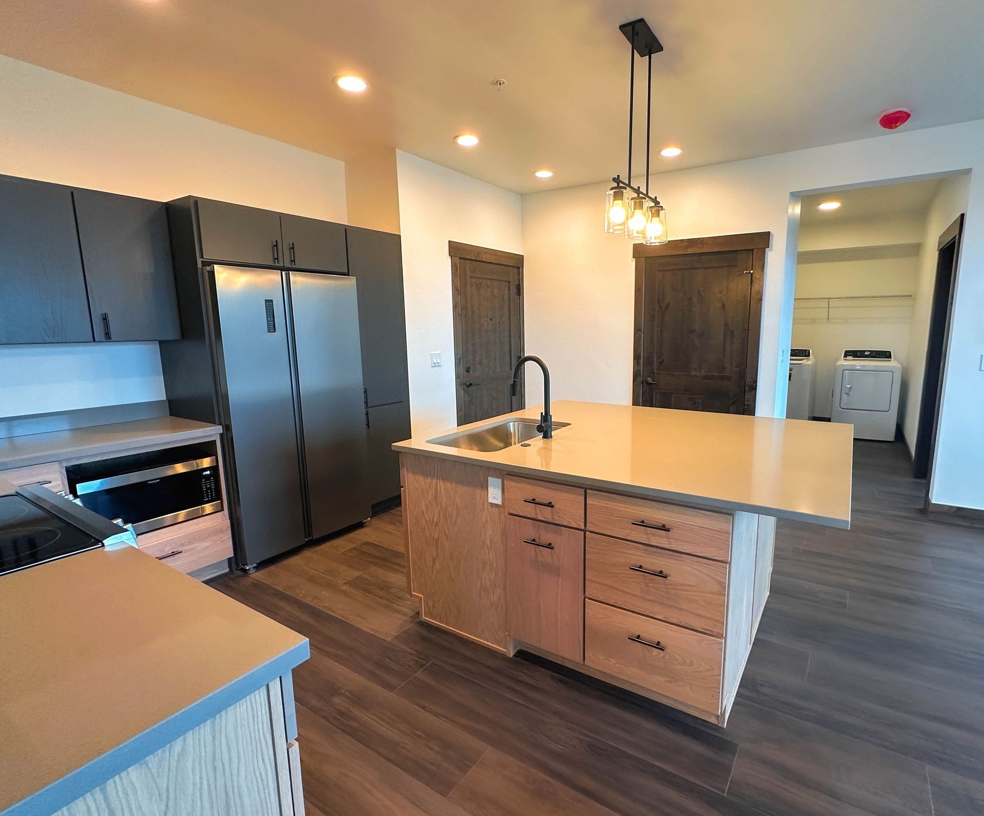 a kitchen with stainless steel appliances and wooden cabinets