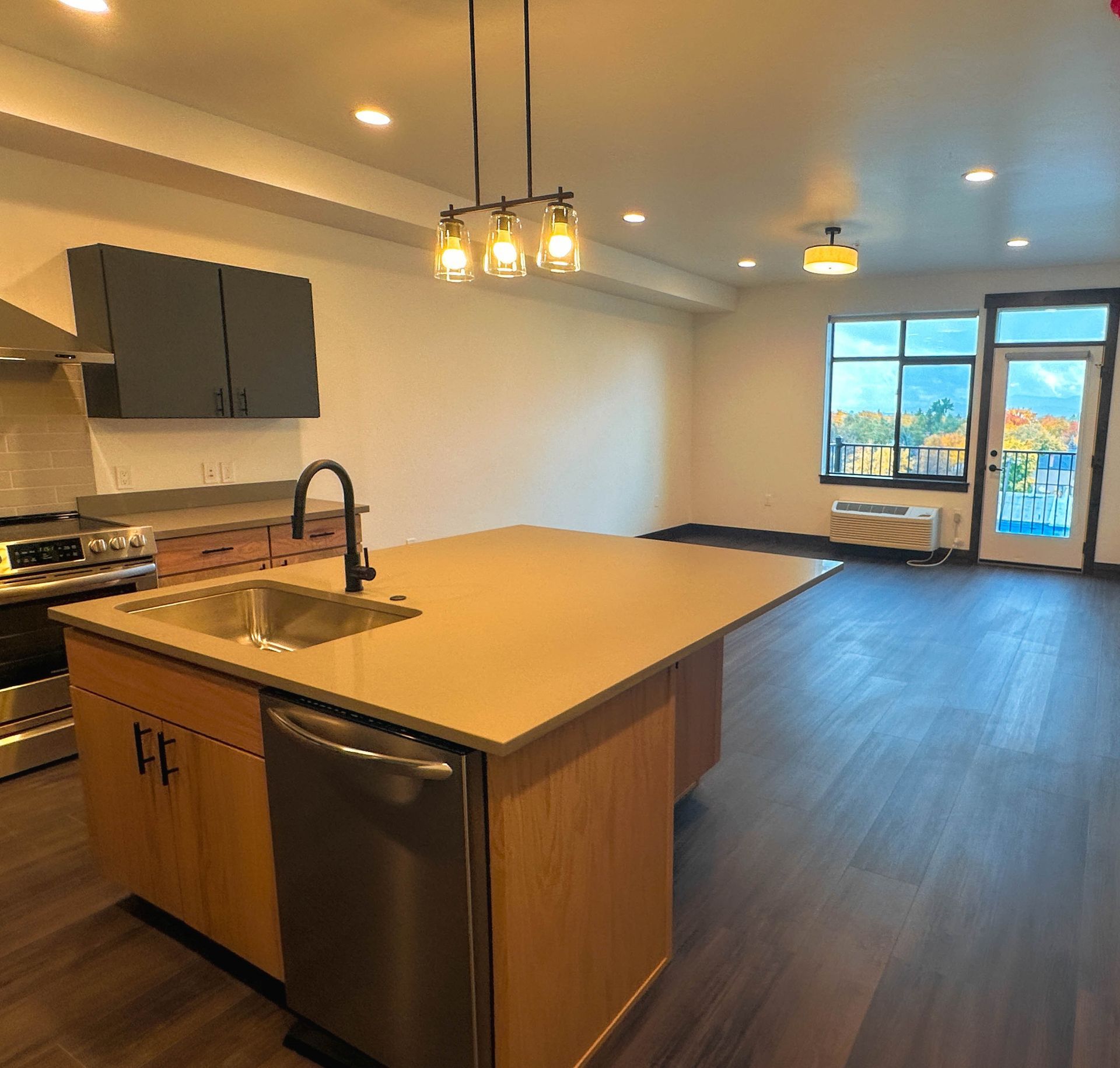 a kitchen with a large island and stainless steel appliances