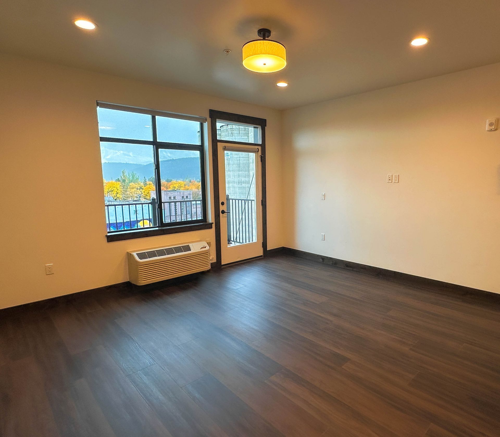 an empty room with a balcony and a window