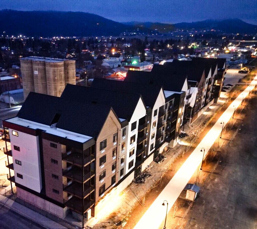 an aerial view of a row of apartment buildings at night
