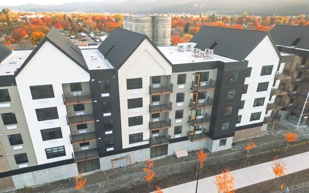 an aerial view of a building with a silo in the background