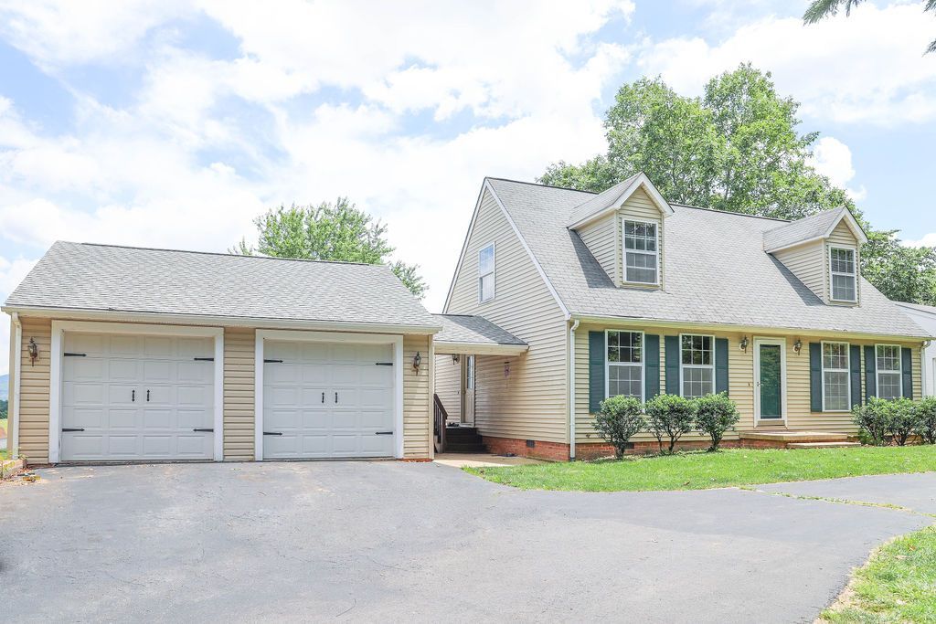 A house with a garage and a driveway in front of it