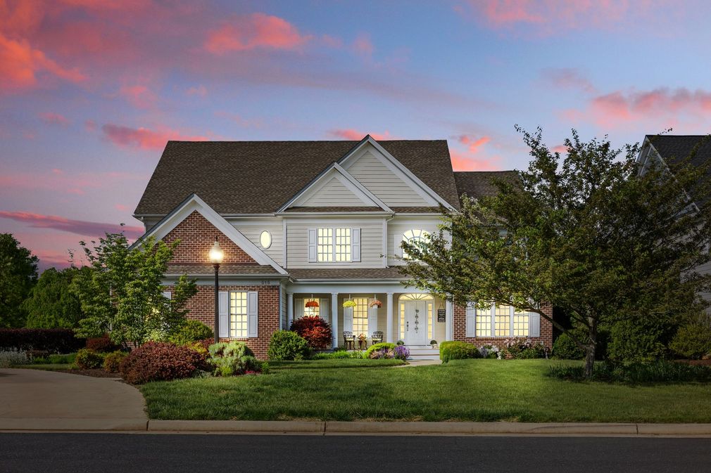 A large house with a lot of windows is lit up at night.