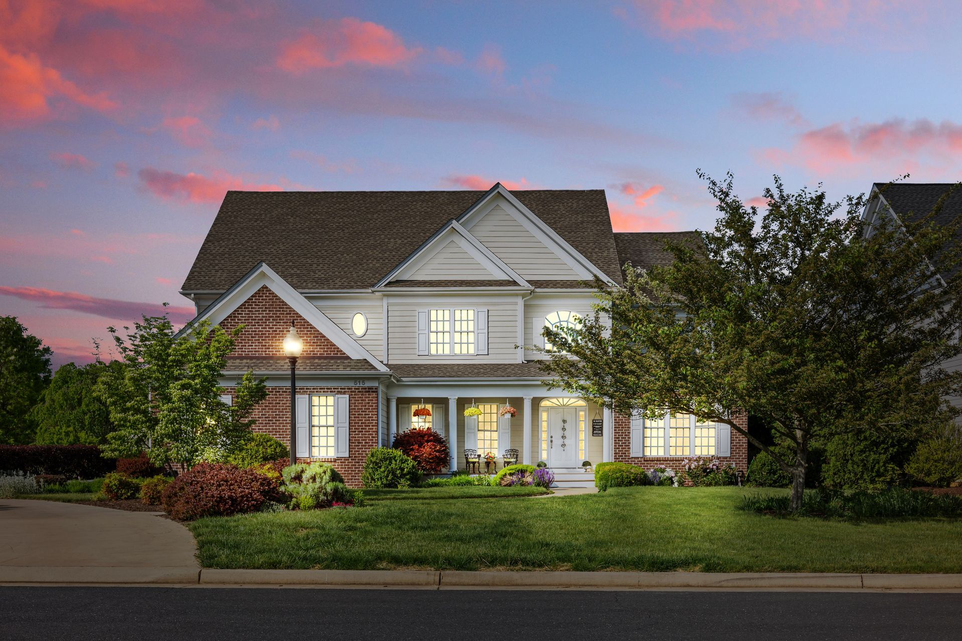 A large house with a lot of windows is lit up at night.