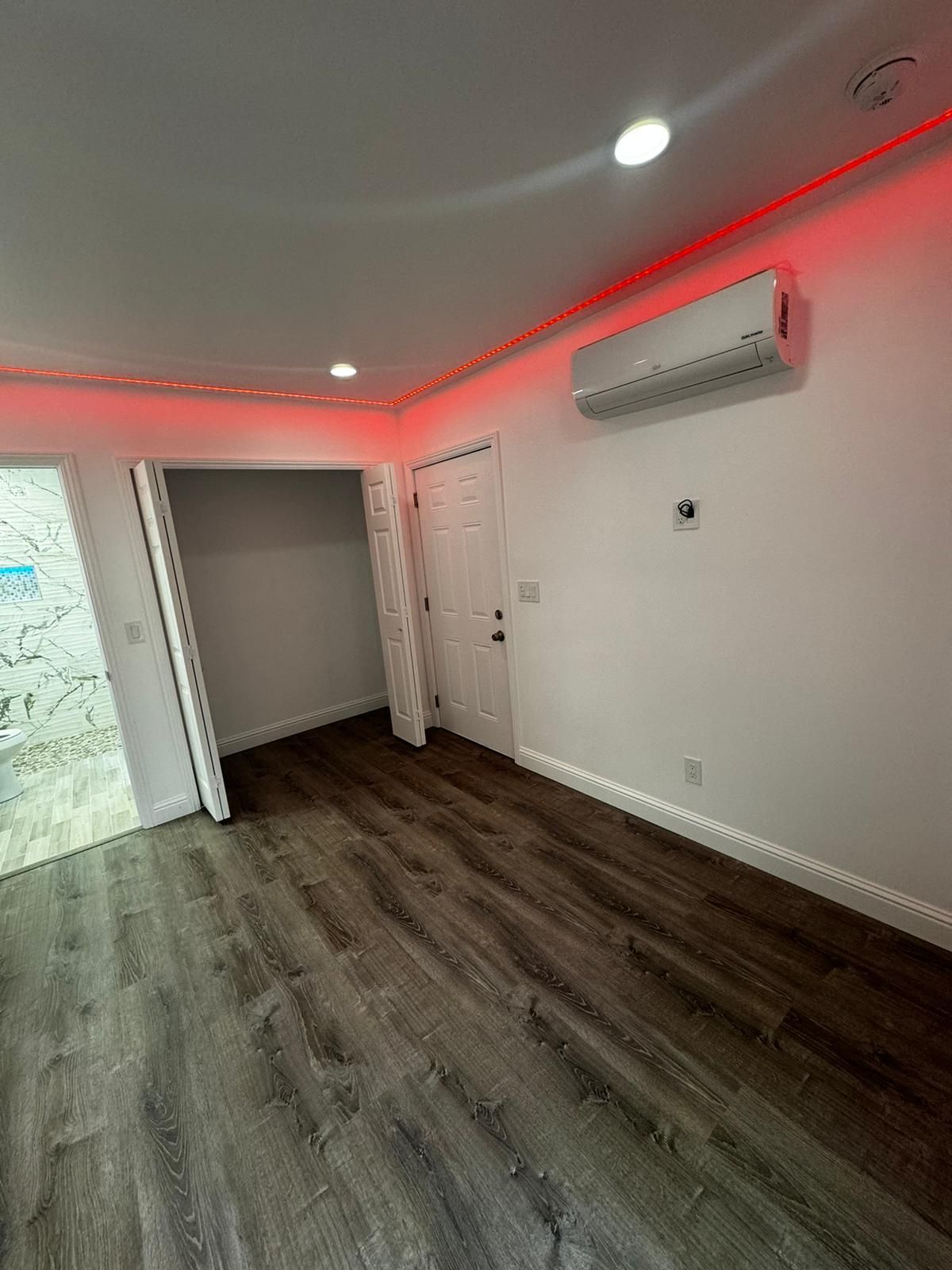 A Room With Hardwood Floors And A Red Light On The Ceiling — Daly City, CA — Turnil Construction, Inc.