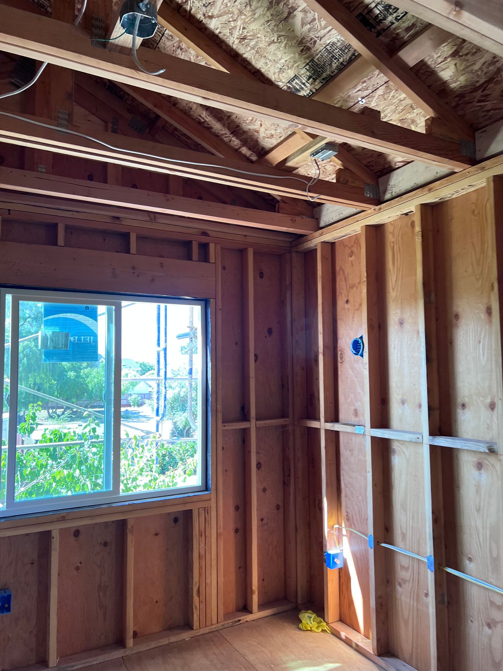 A Room With Wooden Walls And A Window In It — Daly City, CA — Turnil Construction, Inc.
