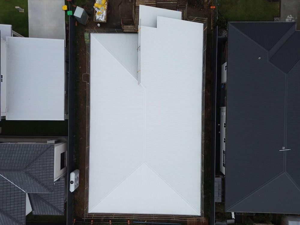 Overhead View of a White Roof on a New Home — Ace1 Metal Roofing in Laurieton, NSW