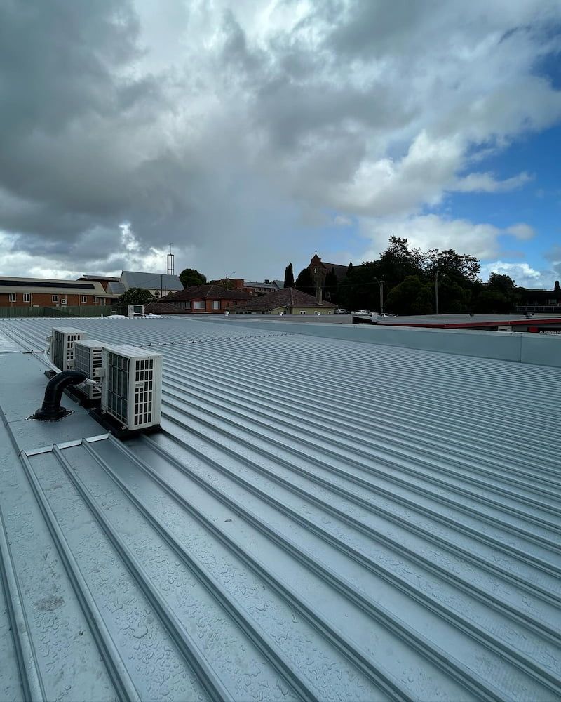 Metal Corrugated Roof With Air Conditioning Units, Cloudy Sky — ACE1 Metal Roofing in Taree, NSW
