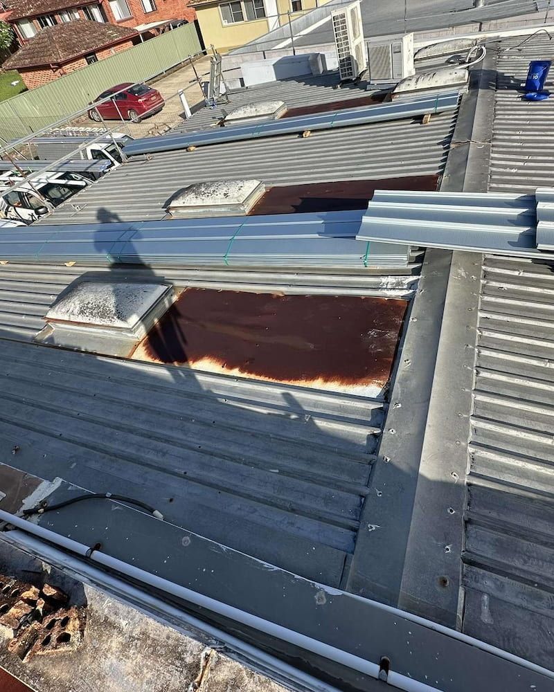 Rusted Skylight on a Corrugated Metal Roof — Ace1 Metal Roofing in Diamond Beach, NSW