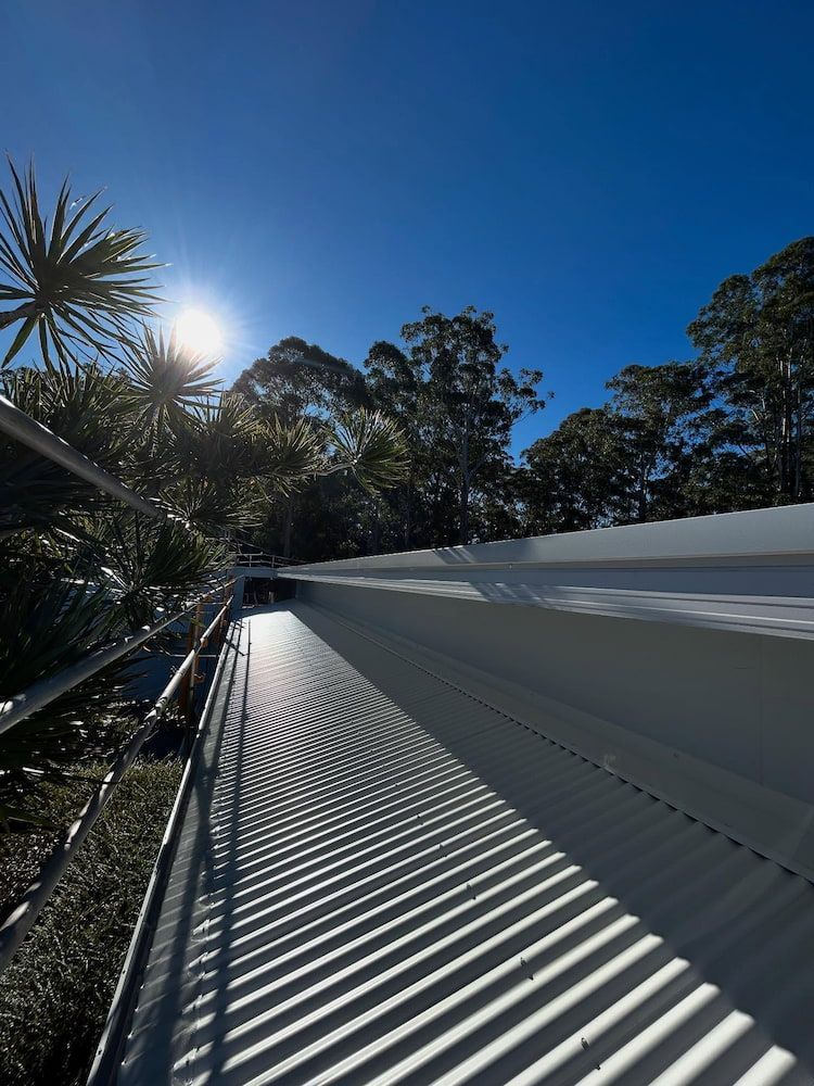 Sunlit Roof With Shadows, Blue Sky, Trees in Background — Ace1 Metal Roofing in Kempsey, NSW