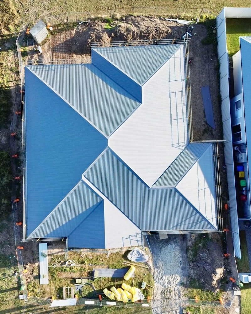 Overhead View of a House Under Construction With a Blue-grey Corrugated Metal Roof — Ace1 Metal Roofing in Harrington, NSW