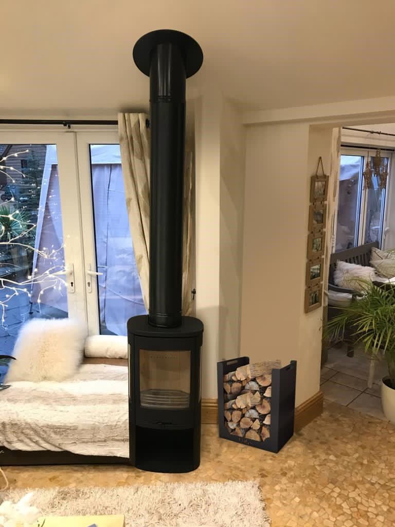 Stove fitted in a brick fireplace