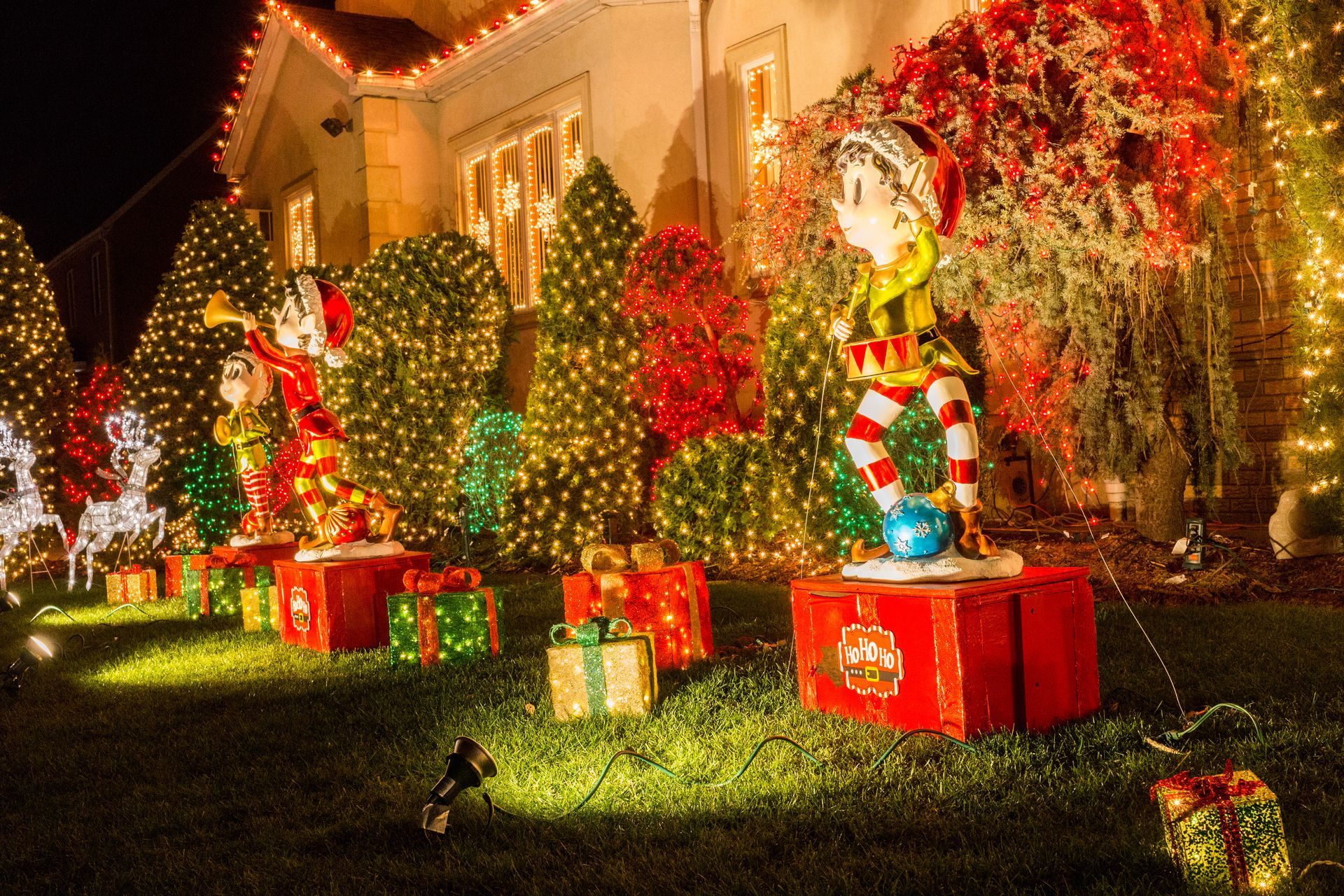 A house is decorated with christmas lights and decorations.