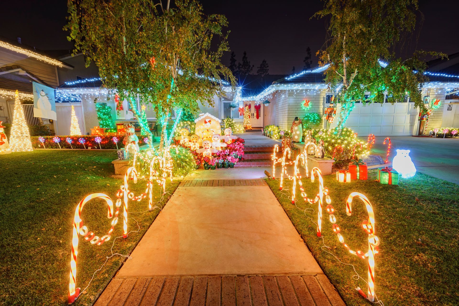 A house is decorated with christmas lights and candy canes.