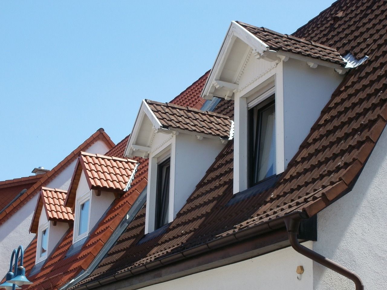 The roof of a house has a few windows on it