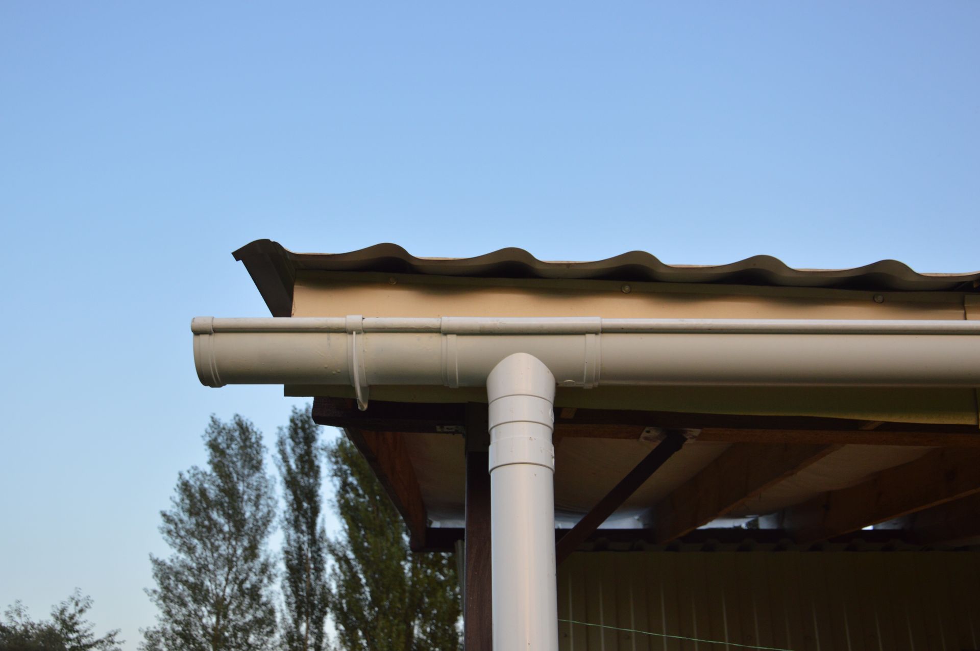 A man is working on the roof of a house.