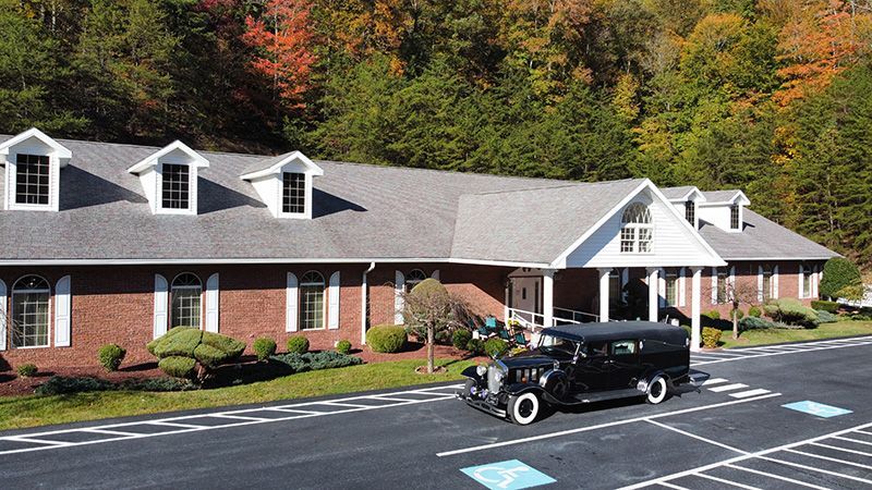 Exterior view of Lucas & Son Funeral Home with 2005 hearse Pikeville, KY