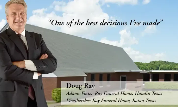 A man in a suit and tie is standing in front of a funeral home