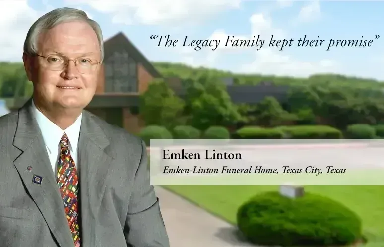 A man in a suit and tie is standing in front of a house