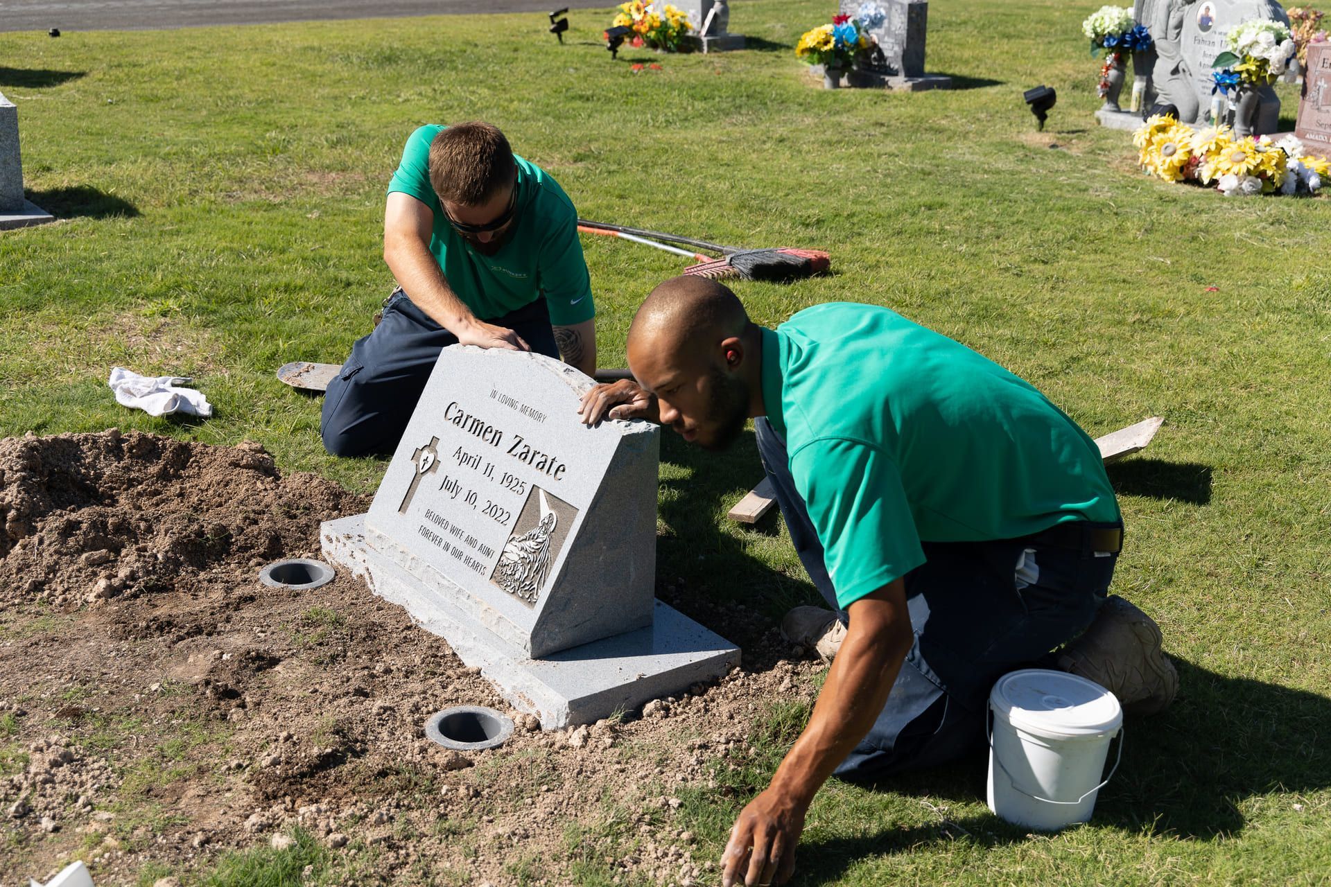 A man and a woman are sitting at a table with a laptop.