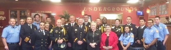 A group of people standing in front of a sign that says underground