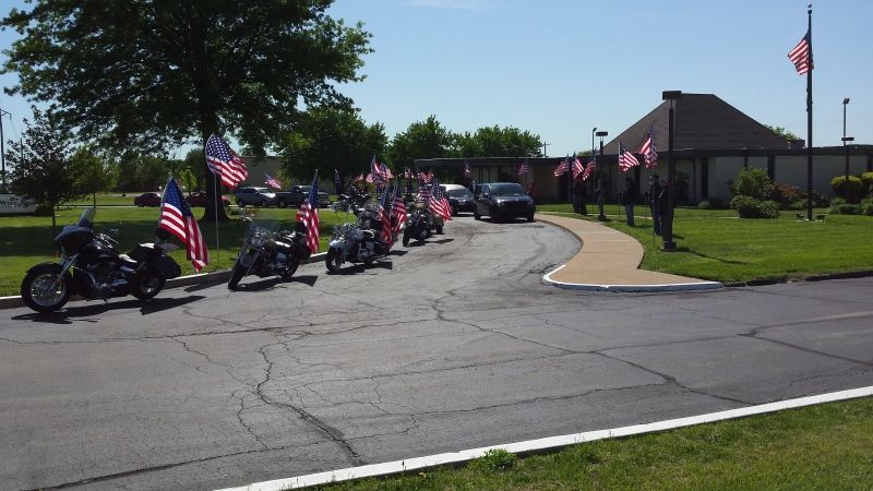 A row of motorcycles are parked on the side of the road