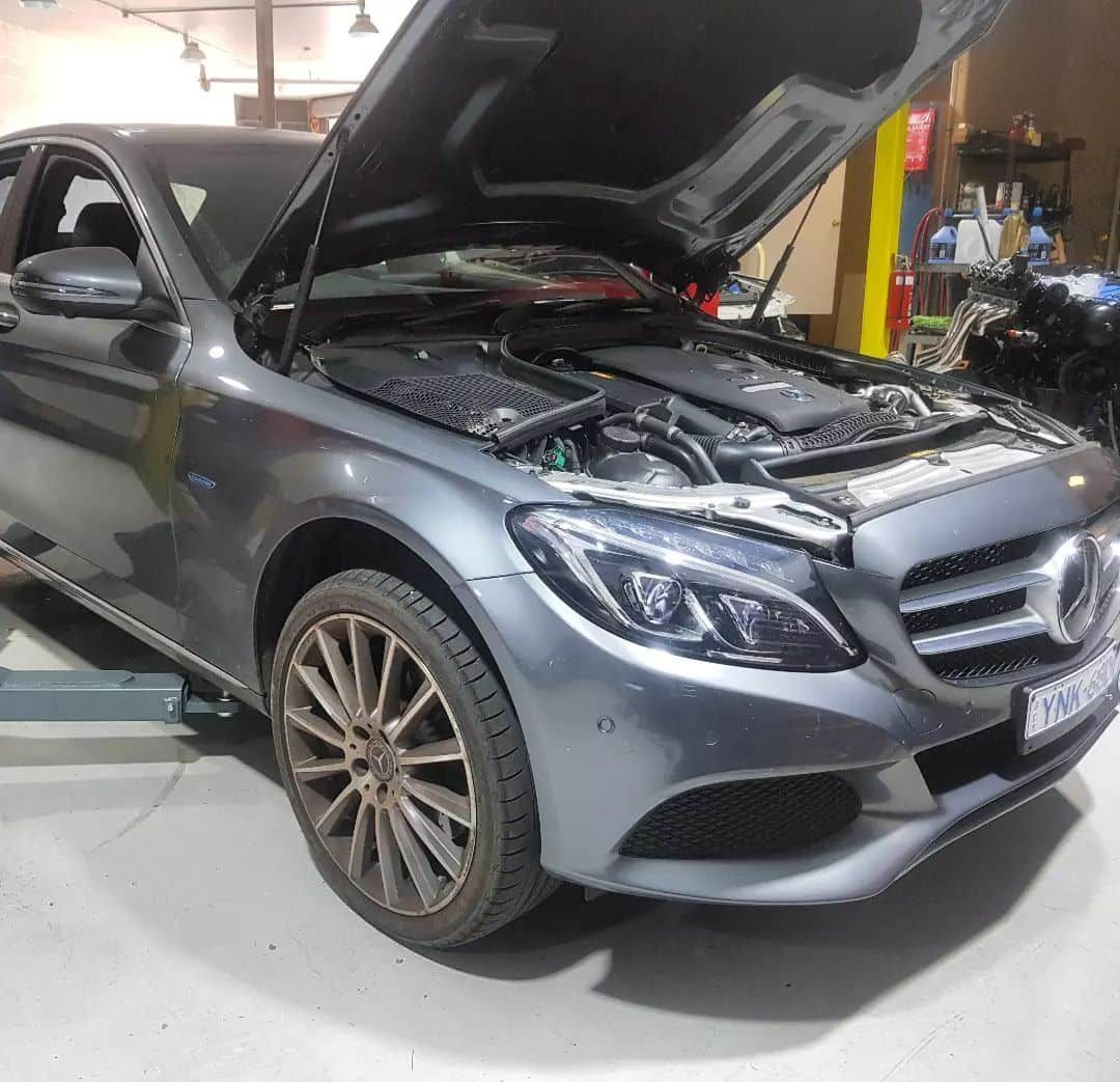 A Car with The Hood up Is Parked in A Garage — Latin Motors in Fyshwick, ACT