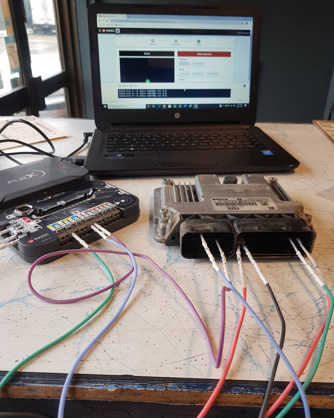 A Laptop with A Bunch of Wires Connected to It — Latin Motors in Fyshwick, ACT