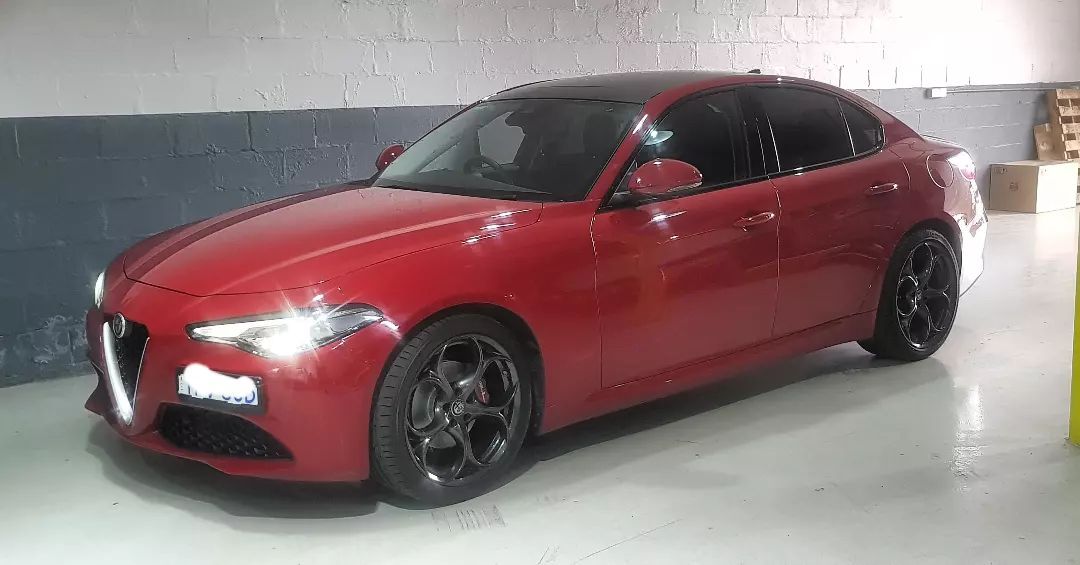 A Red Car Is Parked in A Garage Next to A Wall — Latin Motors in Fyshwick, ACT