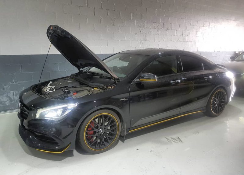 A Black Mercedes Benz Cla 45 Amg with Its Hood Open Is Parked in A Garage — Latin Motors in Fyshwick, ACT