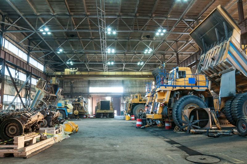 A large warehouse filled with lots of heavy machinery.