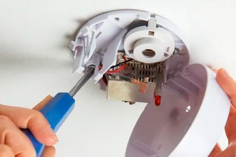 A Person Is Fixing A Smoke Detector With A Screwdriver – Sale, VIC - WR & EL Jones Electrical Contractors