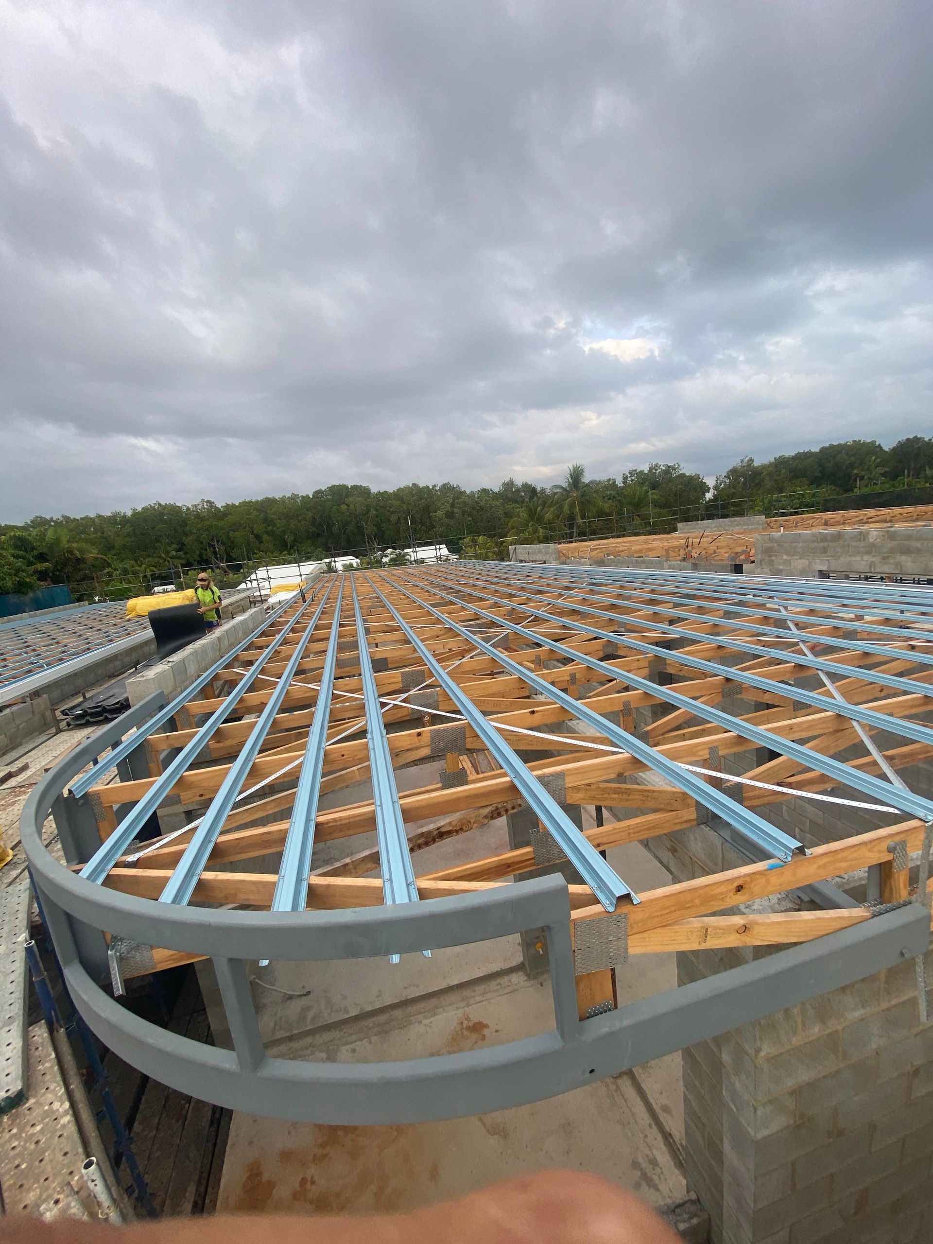 A large wooden structure is being built on top of a building.