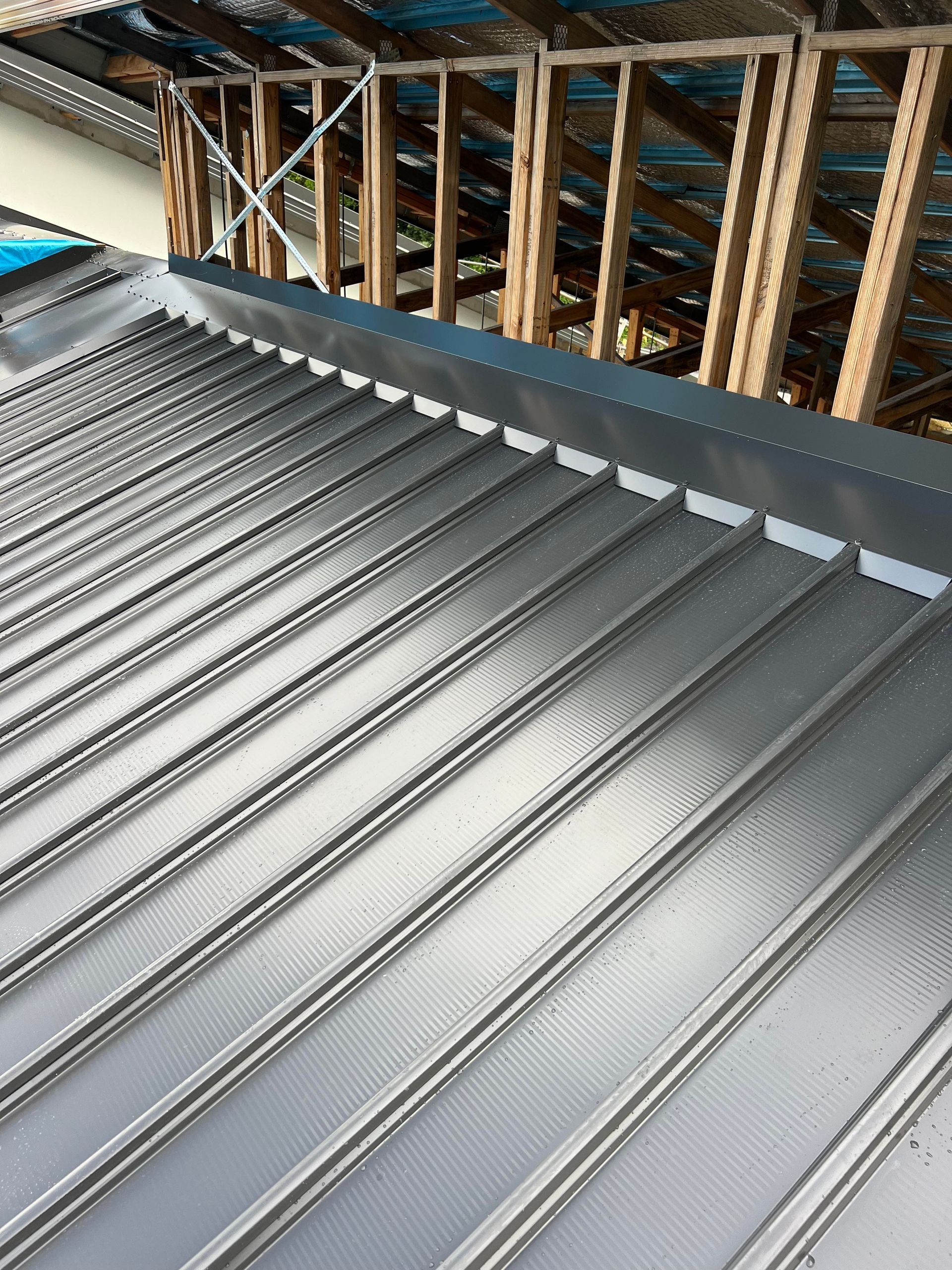 A house is being built in the mountains with a white roof.