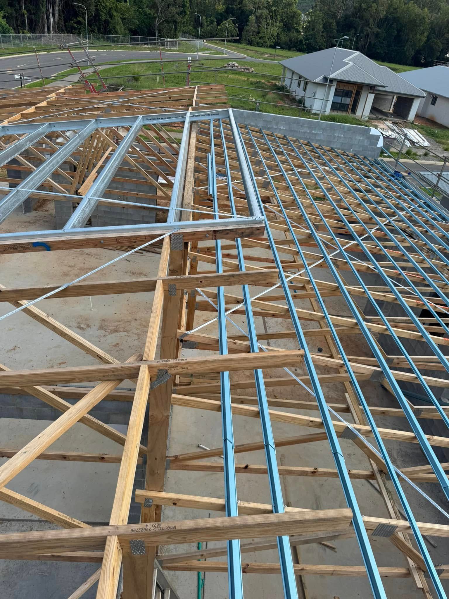 A large wooden structure is being built on top of a building.