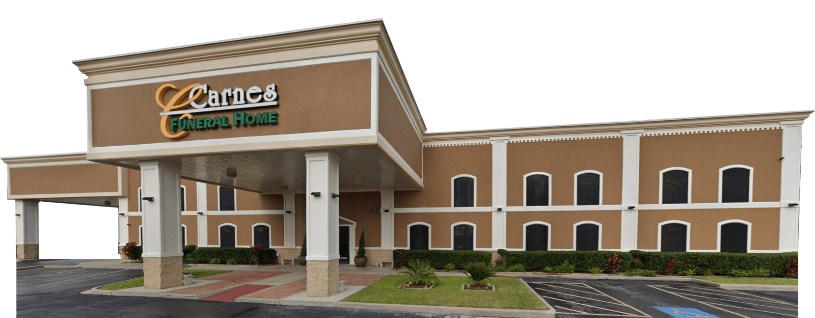 Hotel building with a brown facade, green signage, and a covered entrance.
