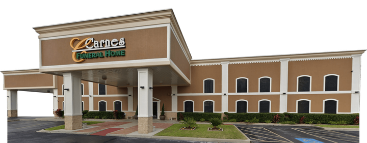 Hotel building with a brown facade, green signage, and a covered entrance.