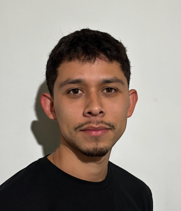 Sergio Soto Man with short dark hair and a thin mustache, wearing a black shirt, looking directly at the camera.