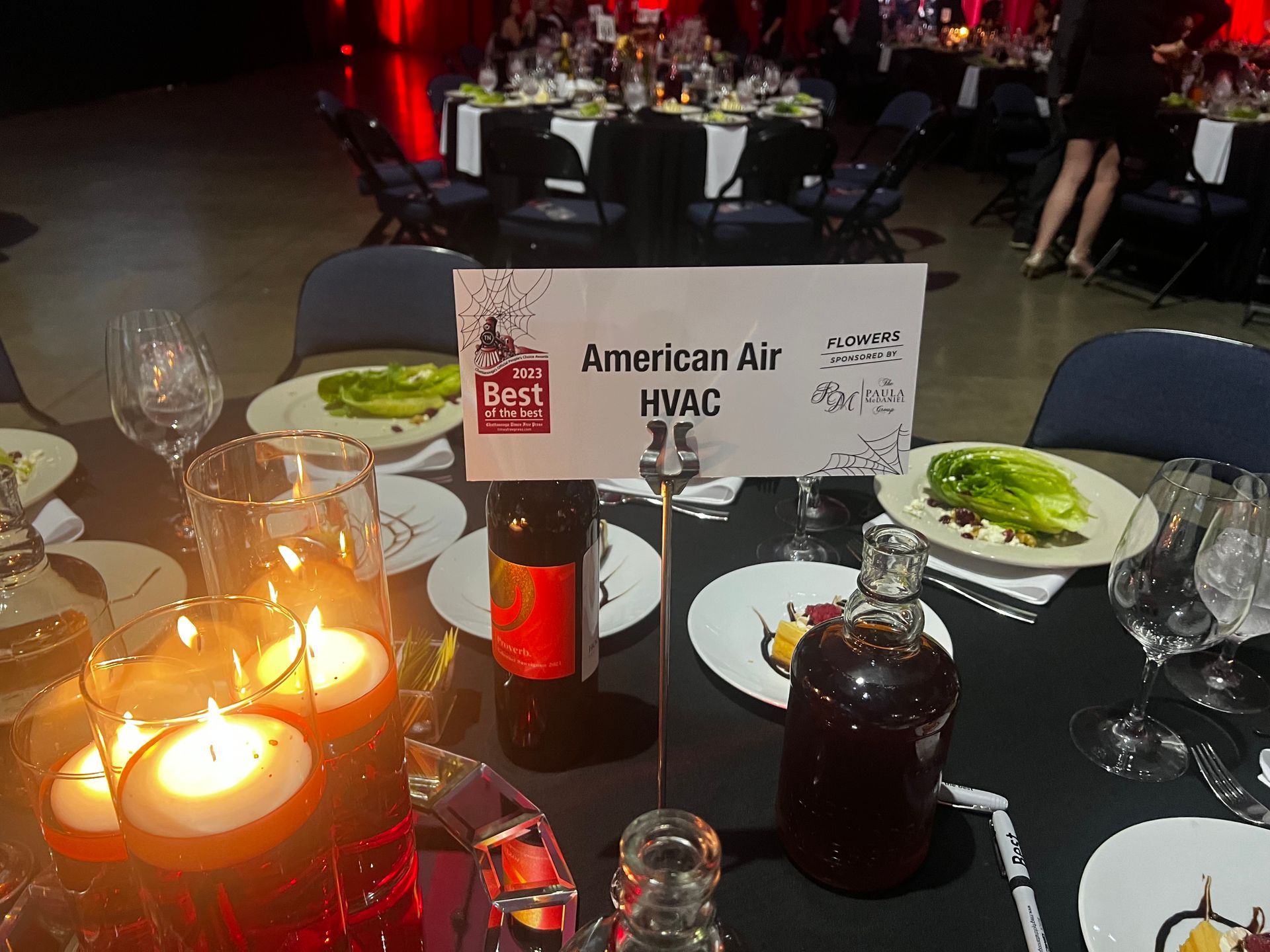 A table with candles and a sign that says american air hvac