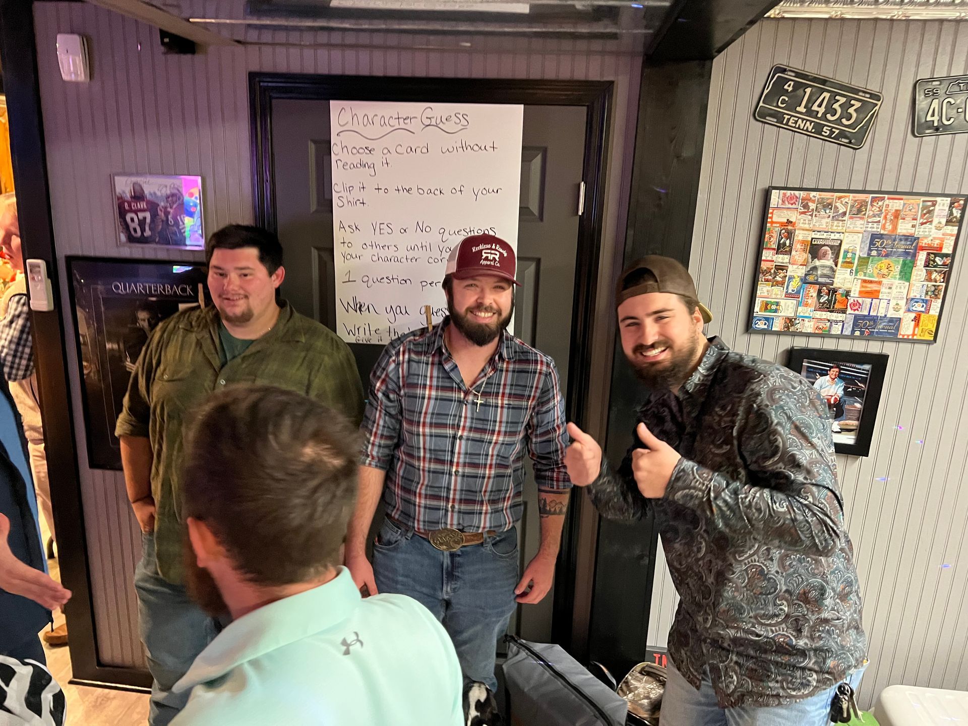 A group of men are posing for a picture in a room.