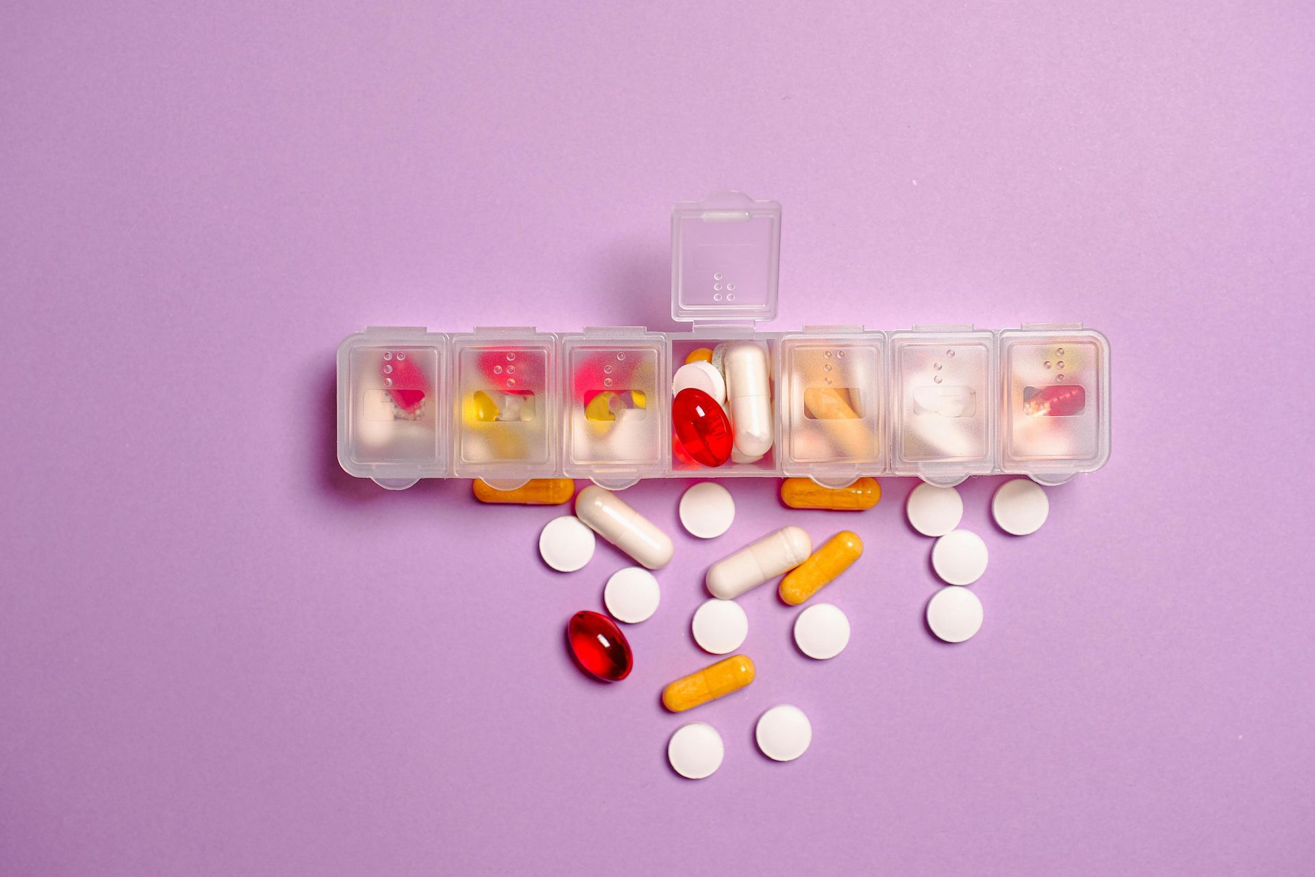 A woman is holding a blister pack of pills in her hands.